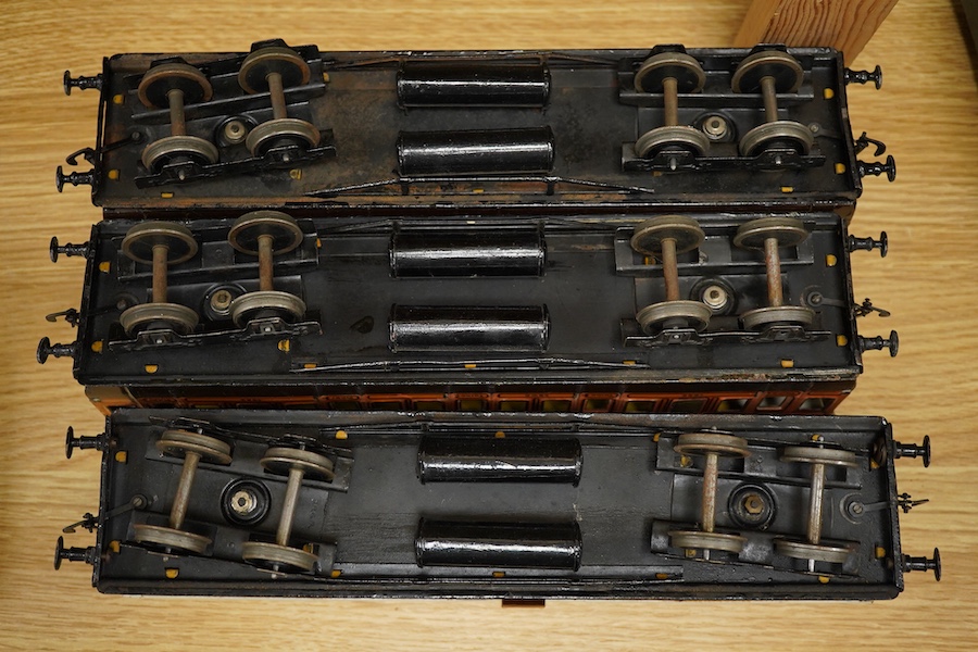 Three Carette for Bassett-Lowke 0 gauge railway 1921 series tinplate LSWR bogie coaches fitted with Bing couplings; two First Third Composite coaches, both 1328, and a full brake van, 133, all in salmon and chocolate liv